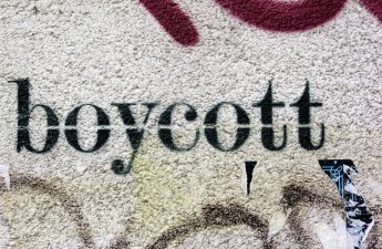 The word 'Boycott' stenciled on a concrete wall.