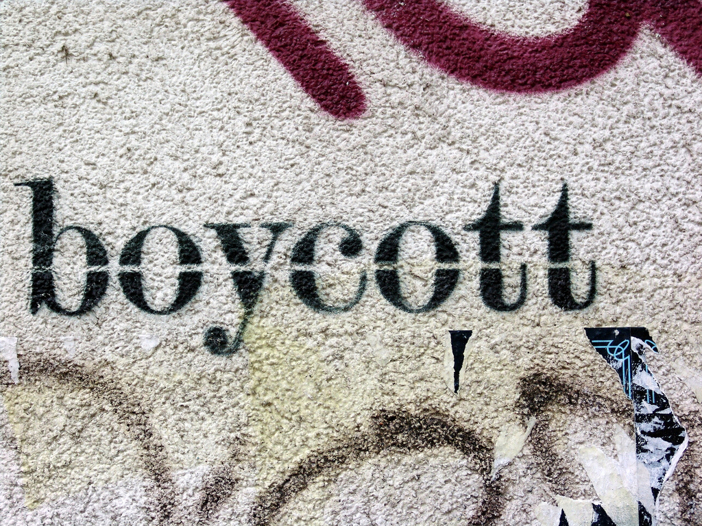 The word 'Boycott' stenciled on a concrete wall.