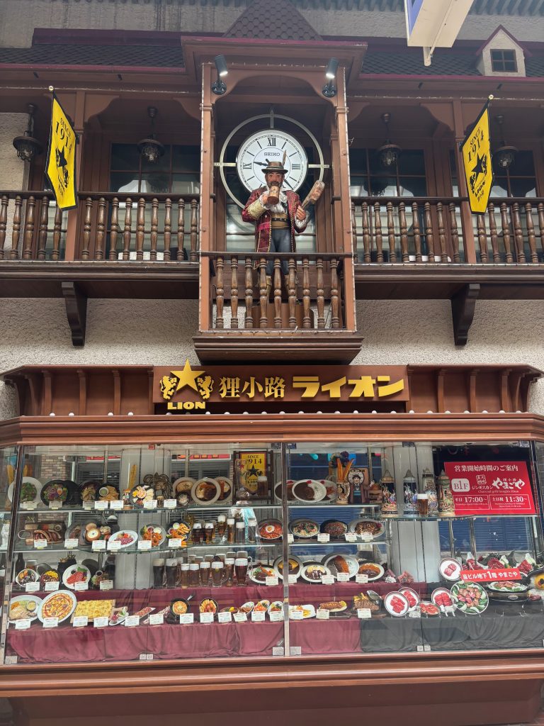 German restaurant facade in Tanukikoji Shopping Street with a wooden man on a balcony
