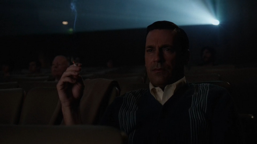 Don Draper smoking in a movie theater